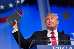 Donald Trump, president and chief executive of Trump Organization Inc. and 2016 Republican presidential candidate, holds up a Bible while speaking at the Values Voter Summit in Washington, D.C., U.S., on Friday, Sept. 25, 2015. The annual event, organized by the Family Research Council, gives presidential contenders a chance to address a conservative Christian audience in the crowded Republican primary contest. Photographer: Drew Angerer/Bloomberg via Getty Images